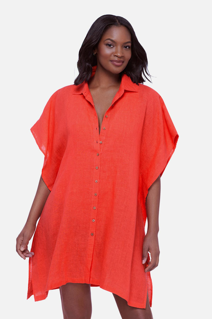 Woman wearing an orange oversized swim cover up shirt