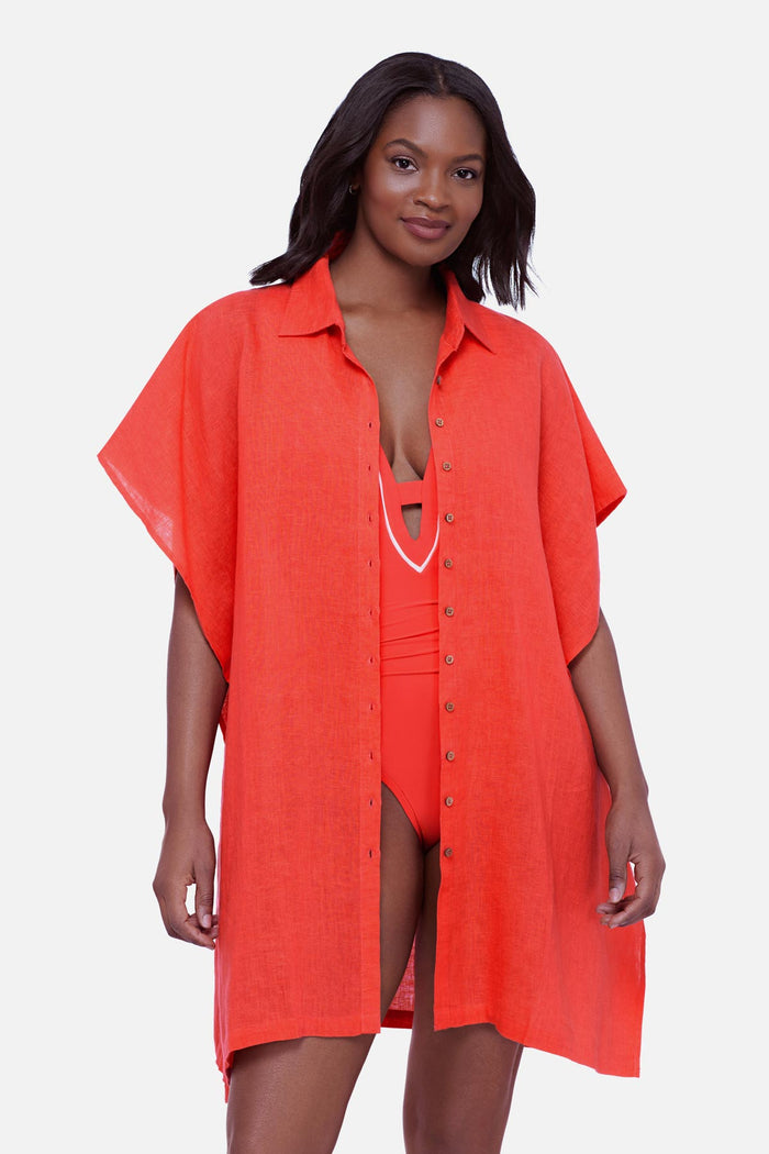 Woman wearing an orange oversized swim cover up shirt