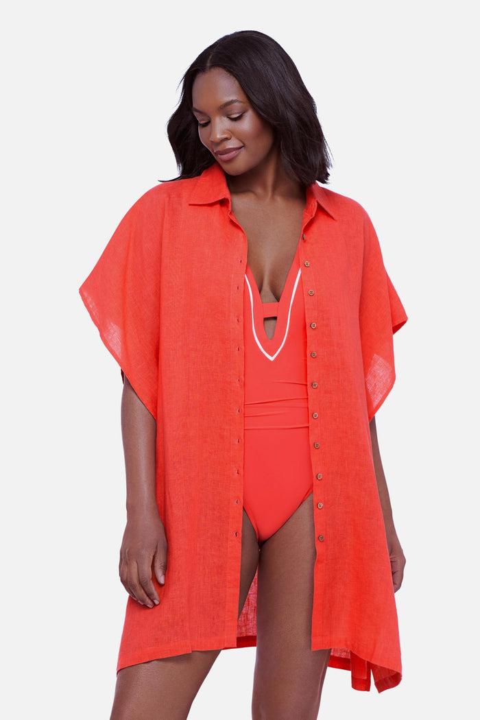 Woman wearing an orange oversized swim cover up shirt