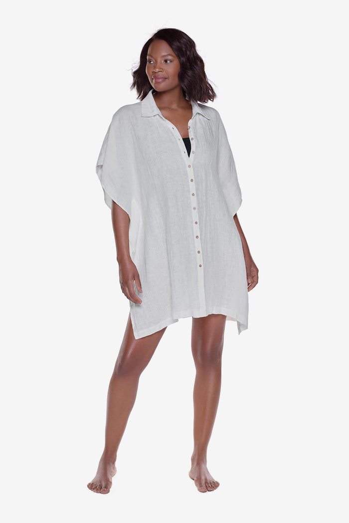 Woman wearing an ivory-colored oversized beach shirt