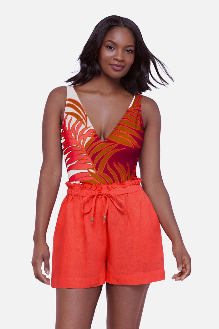 Woman wearing an orange swim short cover up