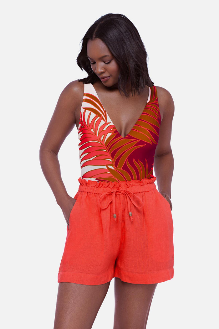 Woman wearing an orange swim short cover up