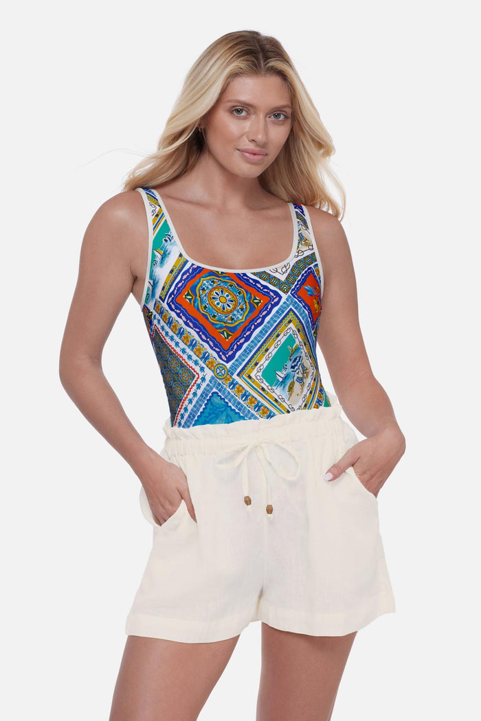 Woman wearing ivory colored swim cover up shorts