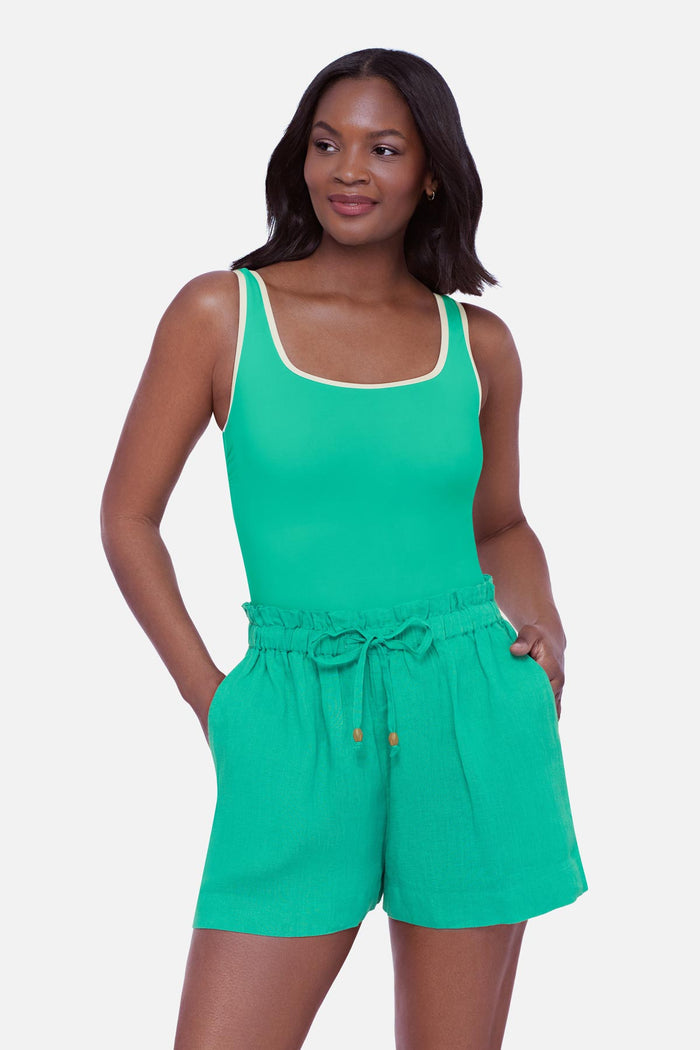 Woman wearing a seafoam green swim short cover up