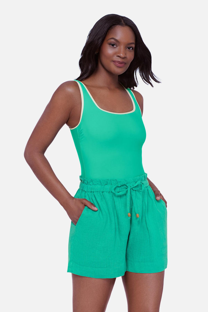 Woman wearing a seafoam green swim short cover up