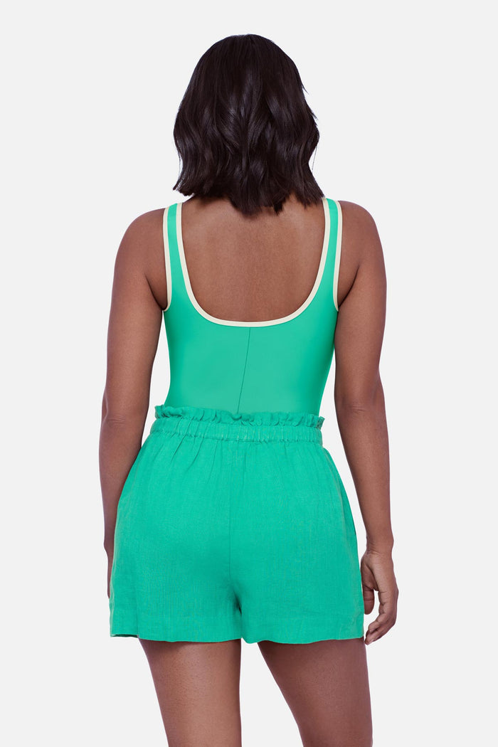 Woman turned away wearing a seafoam green swim short cover up