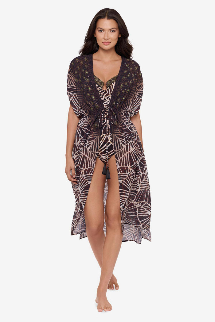 Woman wearing a brown printed kimono swim cover up with a matching swimsuit underneath