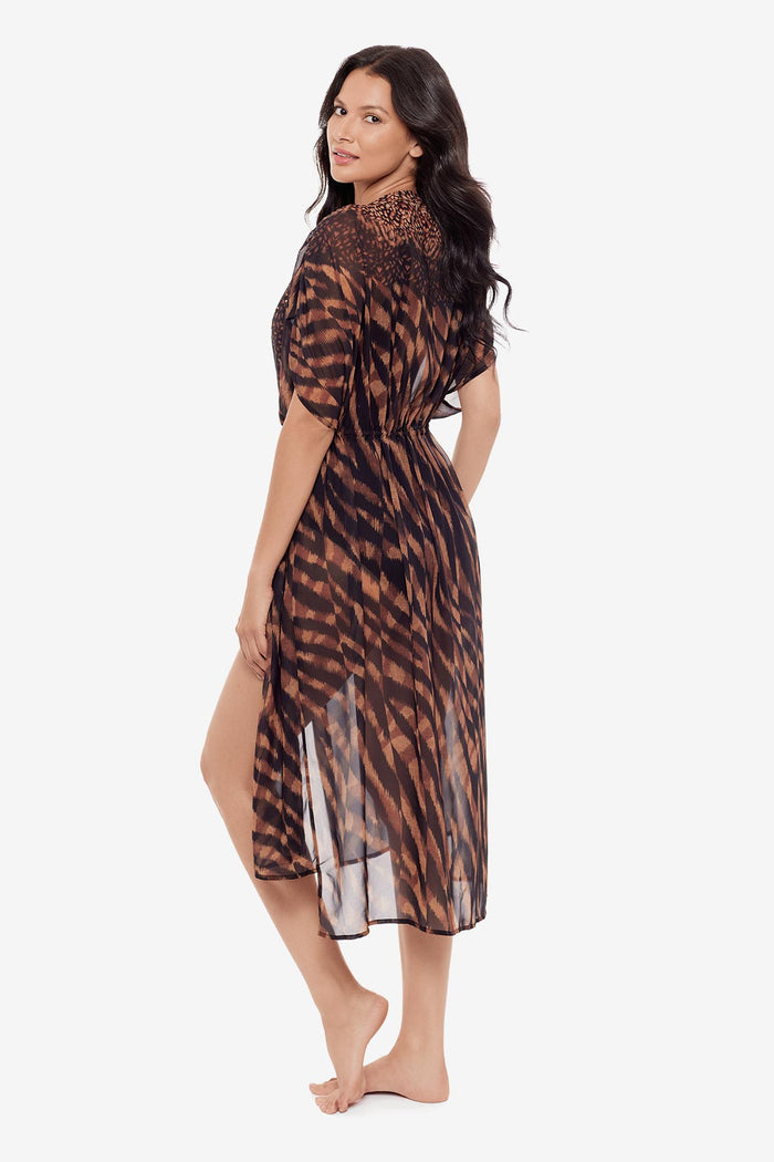 Woman turned left wearing a black and brown beaded kimono style swim cover up
