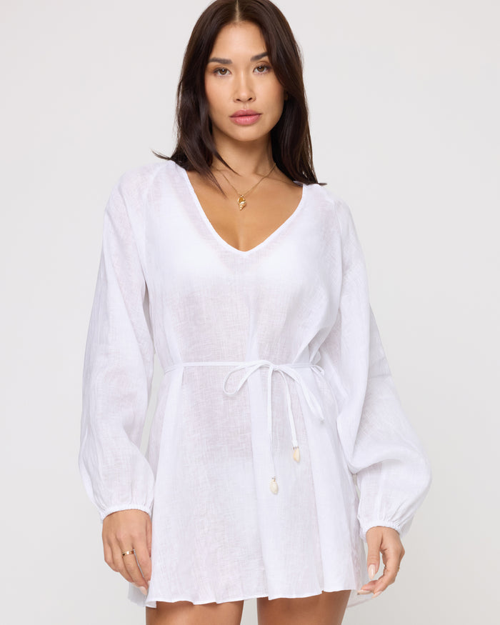 Front view of a model wearing the LSPACE Boat Trip Tunic in white, styled with a drawstring tie at the waist with shell tassel detail.