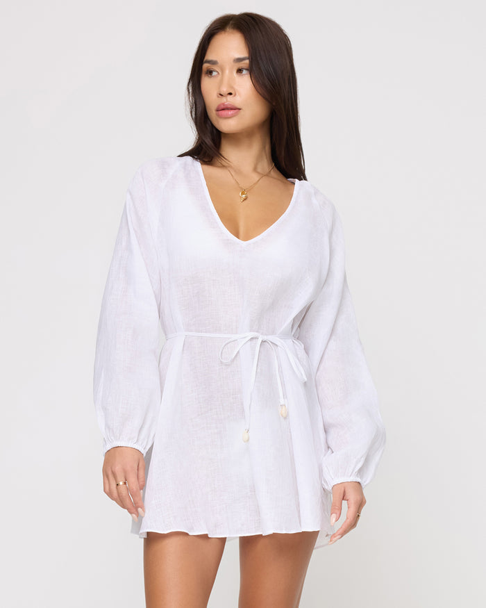 Front view of a model wearing the LSPACE Boat Trip Tunic in white with a drawstring tie at the waist, showing the V-neckline and sheer linen fabric.