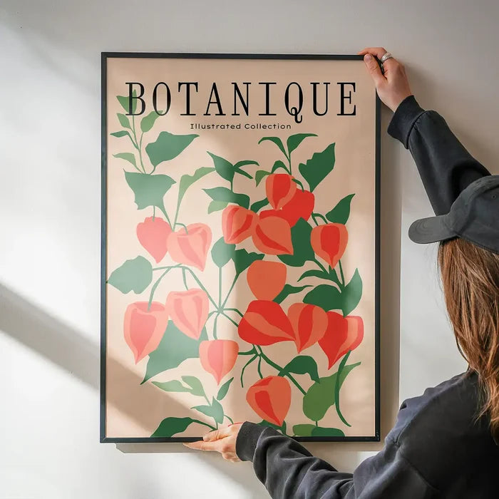 Botanique Illustrated Floral Print being hung on a wall in a black frame