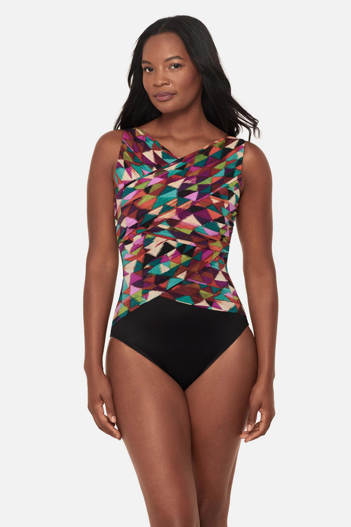 Woman wearing a multicolored geometric high neck one-piece swimsuit