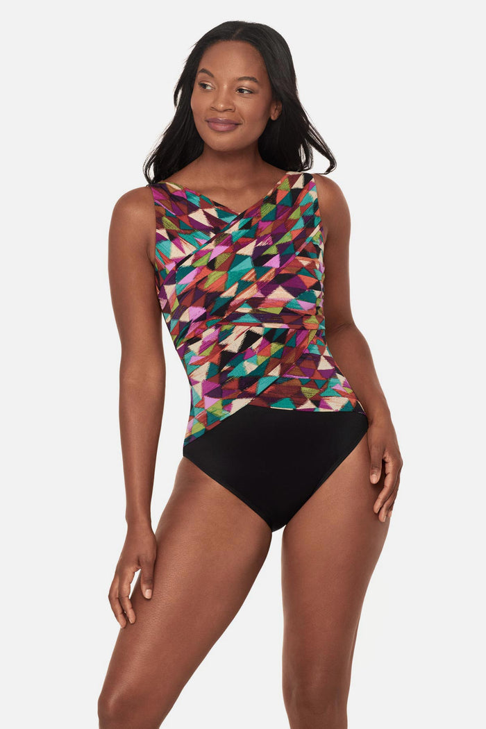 Woman wearing a multicolored geometric high neck one-piece swimsuit