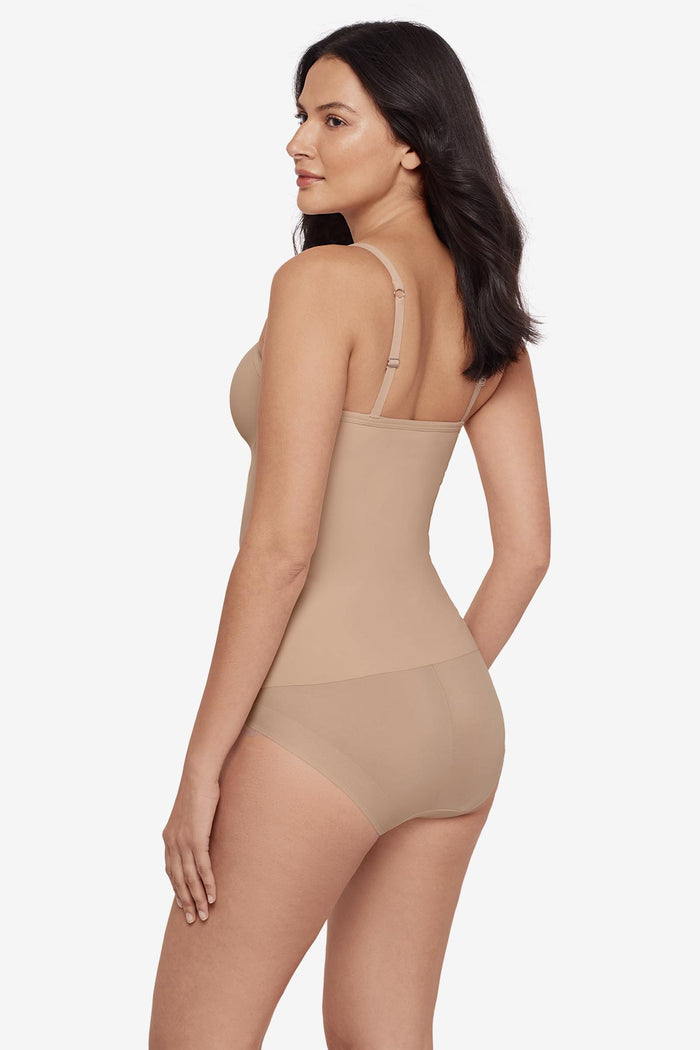 Woman faced left wearing a tan cupped bra cami top