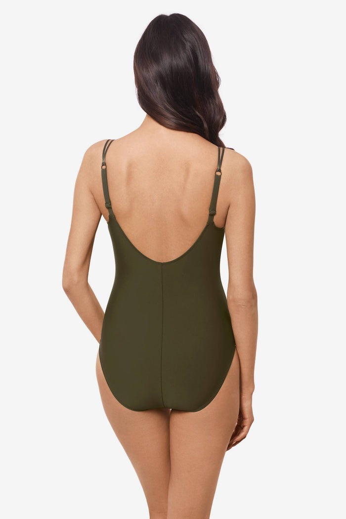 Woman facing away wearing a bamboo green one-piece swimsuit