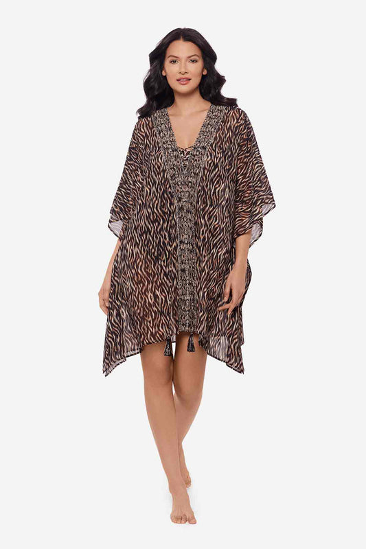 Woman wearing multicolor print swimsuit cover up with tassels