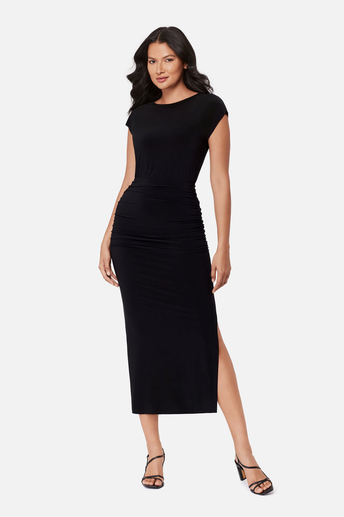 Woman wearing a black short sleeve dress with side slit