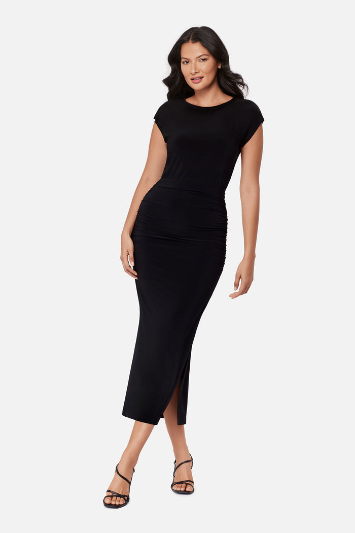 Woman wearing a black short sleeve dress with side slit