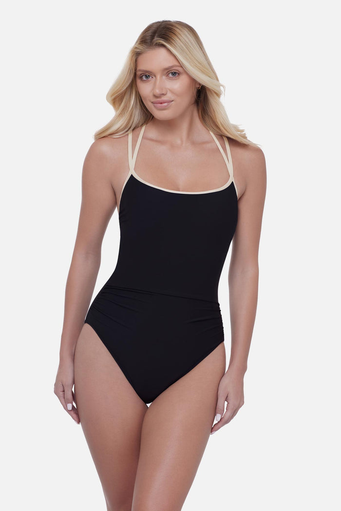 Woman wearing a black one-piece swimsuit with white double straps