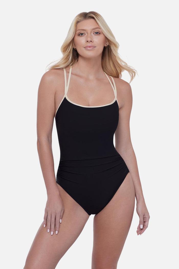 Woman wearing a black one-piece swimsuit with white double straps