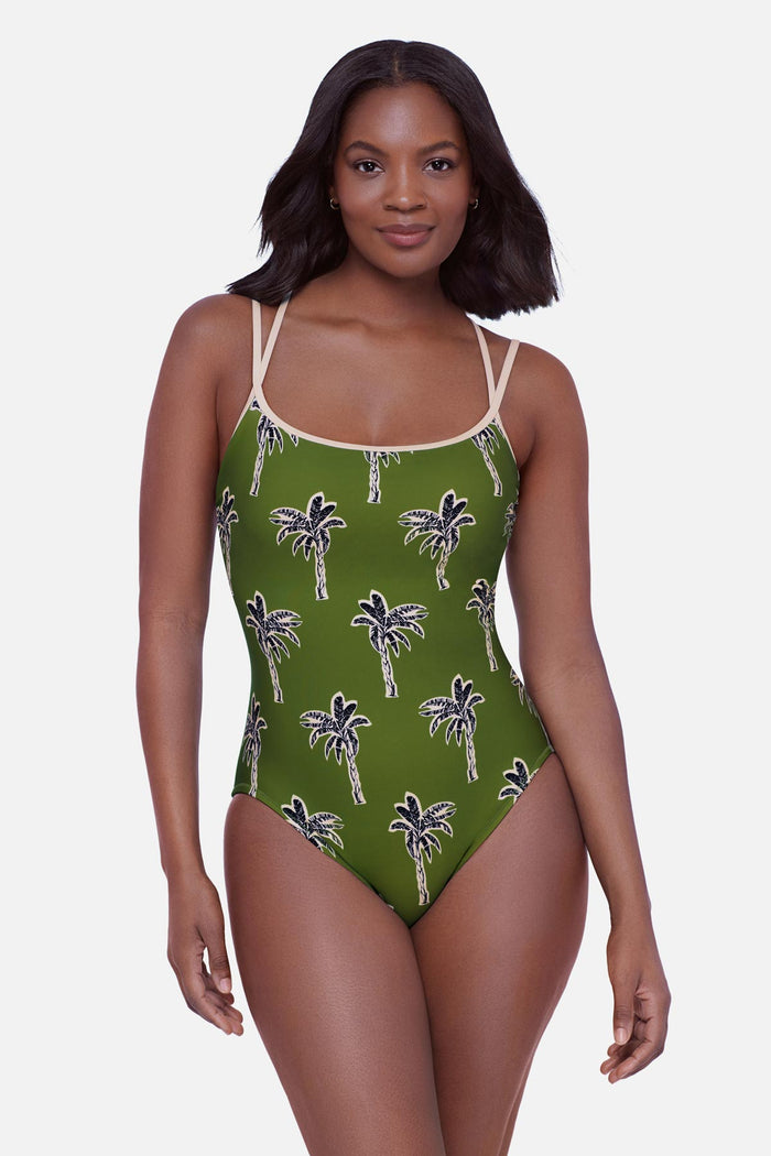 Woman wearing a green palm tree printed one-piece swimsuit