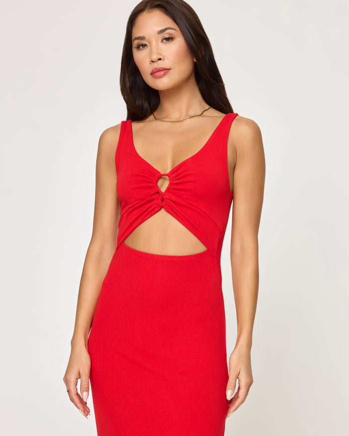 Close-up front view of a model wearing the LSPACE Camille Dress in flame, highlighting the keyhole bust cutout, twist detail, and waist cutout.