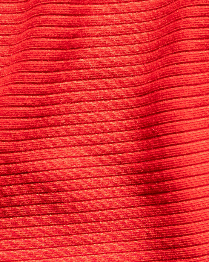 Close-up fabric swatch of the LSPACE Camille Dress in flame, showcasing the ribbed texture of the flame red material.