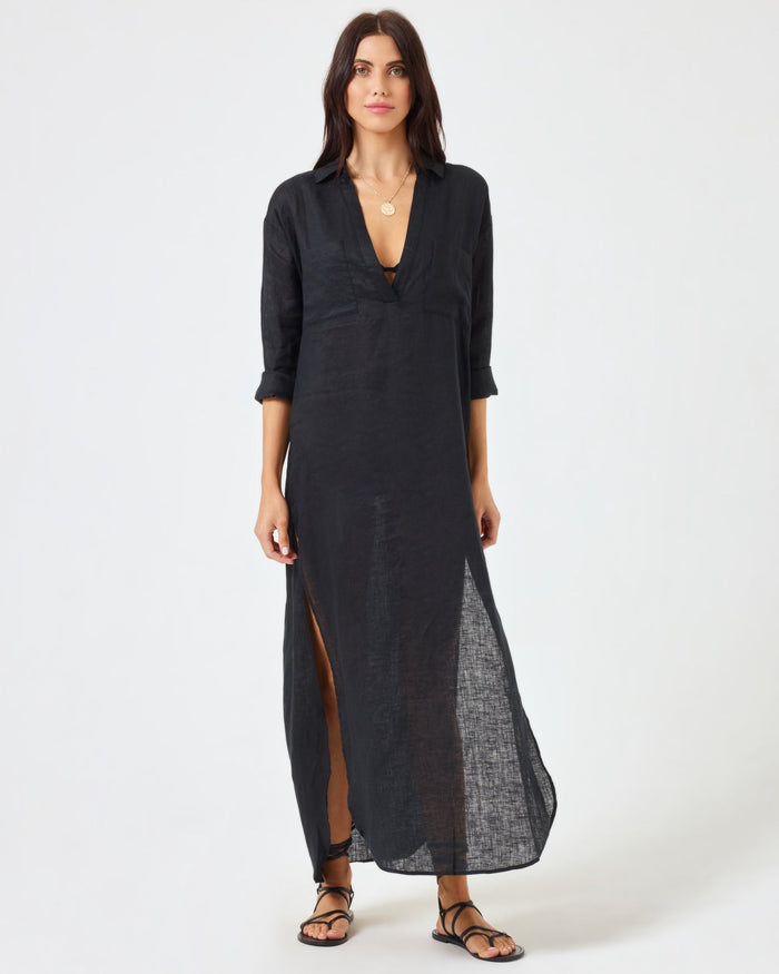 Front view of a model wearing the LSPACE Capistrano Tunic in black, a sheer linen maxi with a deep V-neck collar.
