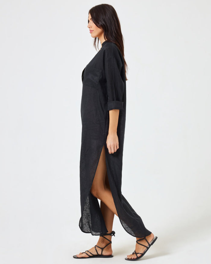Side view of a model walking in the LSPACE Capistrano Tunic in black linen.