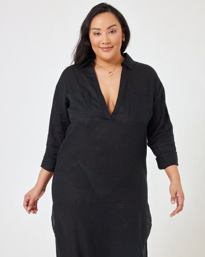 Close-up front view of a model wearing the LSPACE Capistrano Tunic in black, highlighting the deep V-neck collar detail.