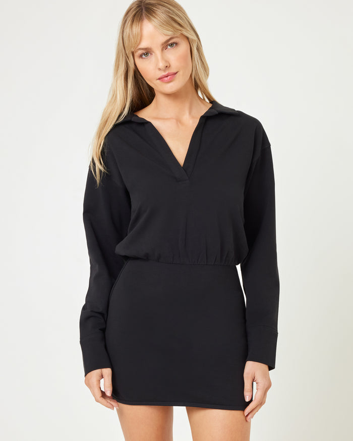 Close-up front view of model wearing the Carson Dress in black, a long sleeve mini dress.