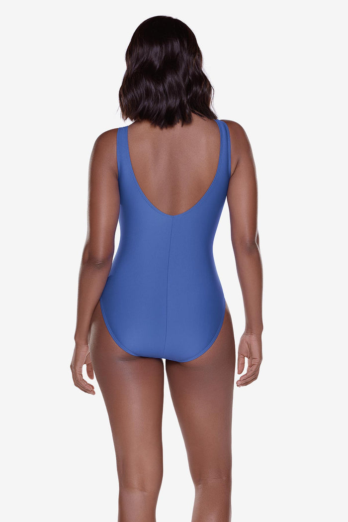 Woman turned away wearing a blue one-piece swimsuit