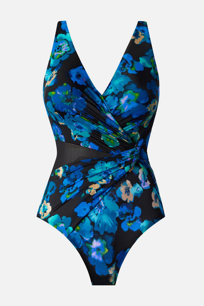 Woman wearing a black and blue floral printed one-piece swimsuit