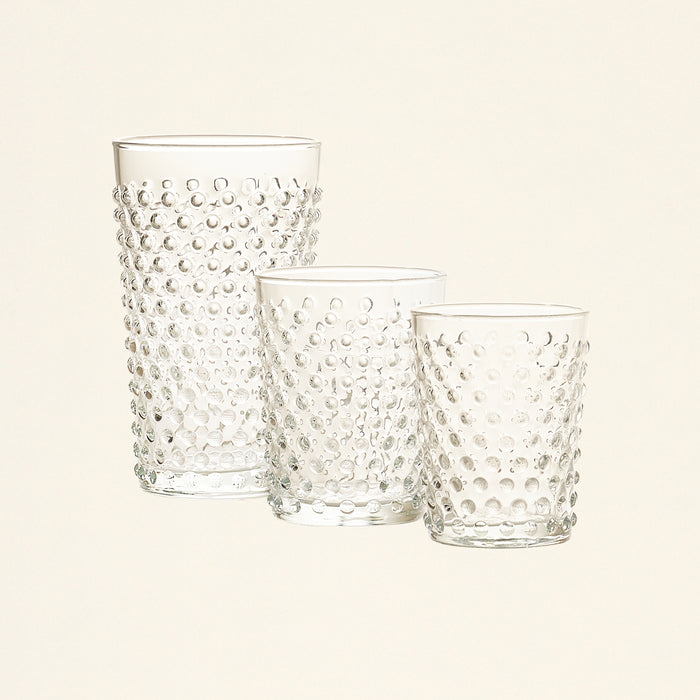 Set of three clear glasses with a raised dot pattern in varying sizes.