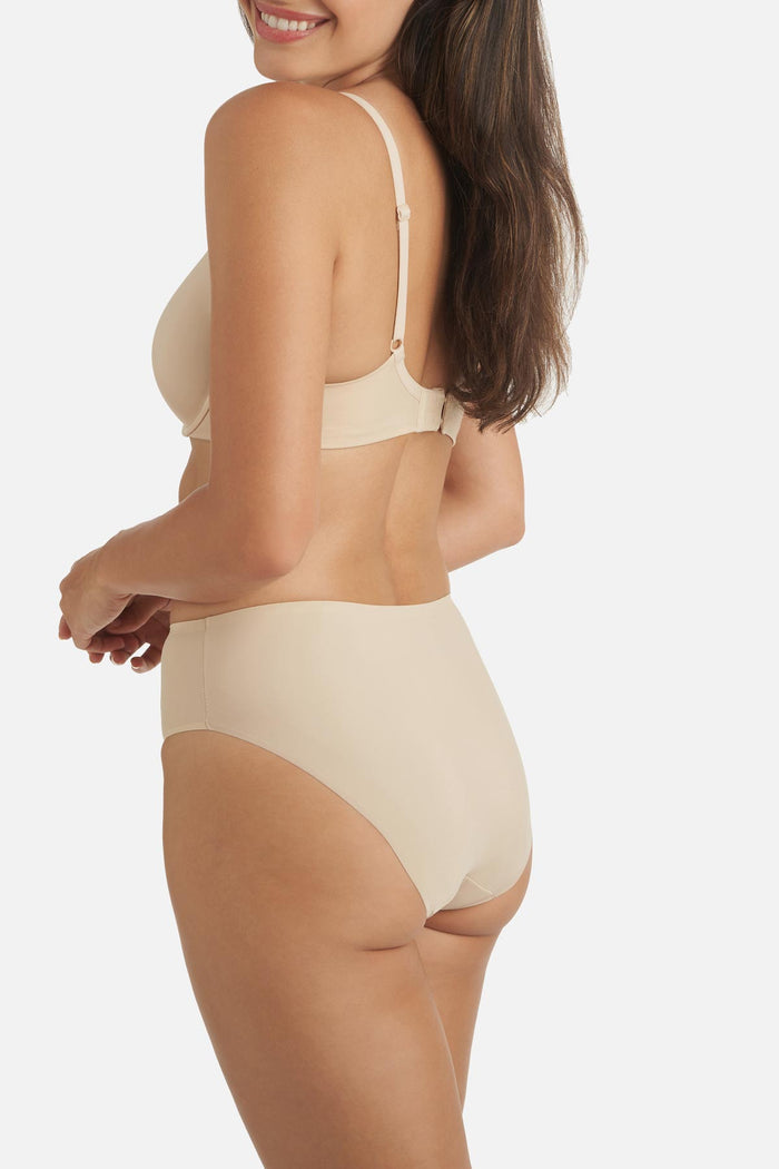 Woman turned left wearing a tan colored shaping panty