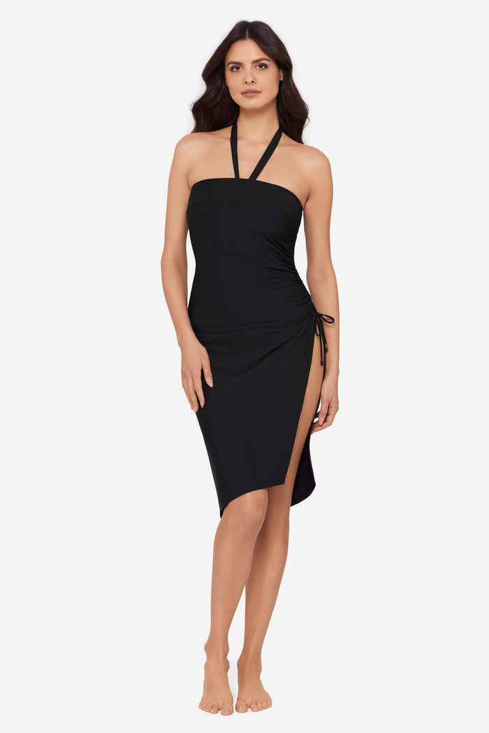 Woman wearing a black swim cover up with a large side slit