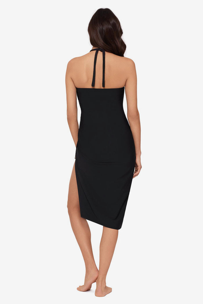 Woman turned away wearing a black swim cover up with a large side slit