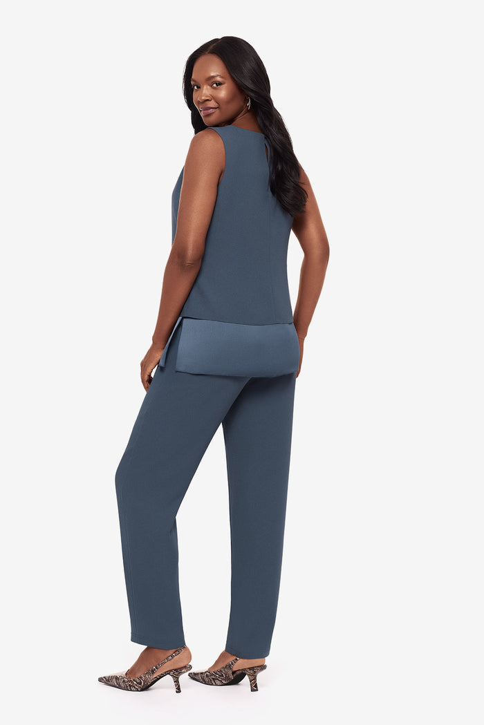Woman turned left wearing a blue layered tunic blouse with matching jogger pants