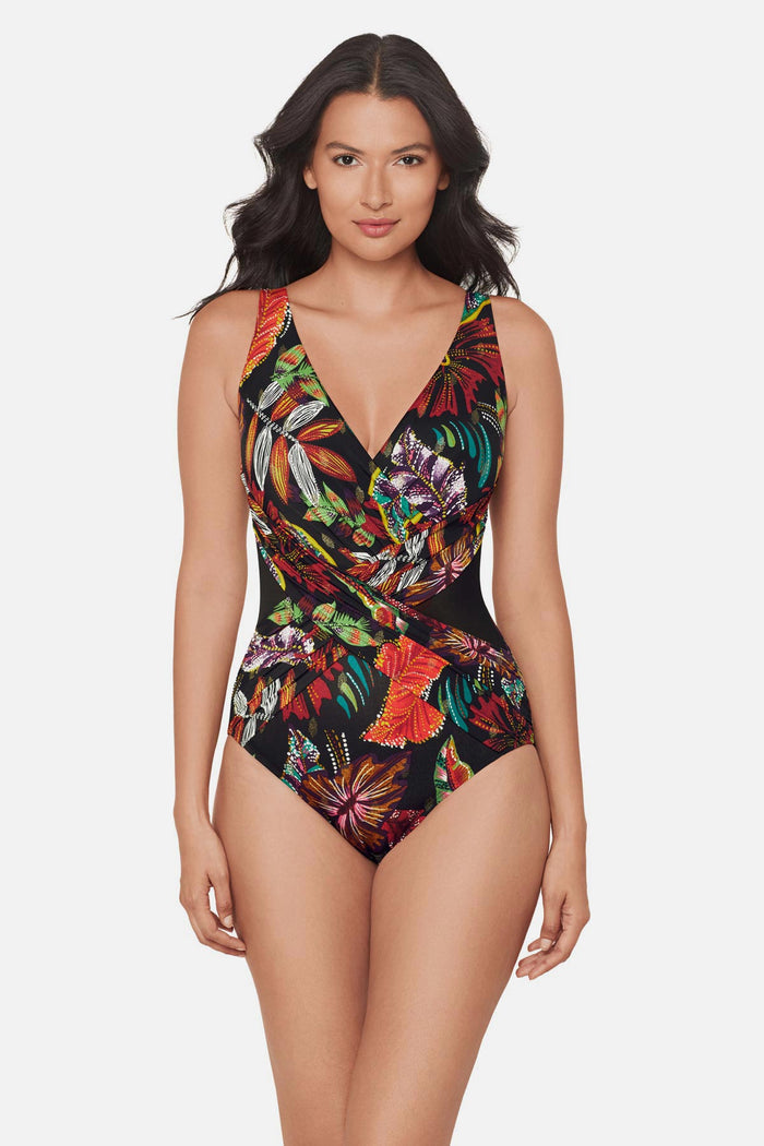 Woman wearing a multicolored floral printed one-piece swimsuit