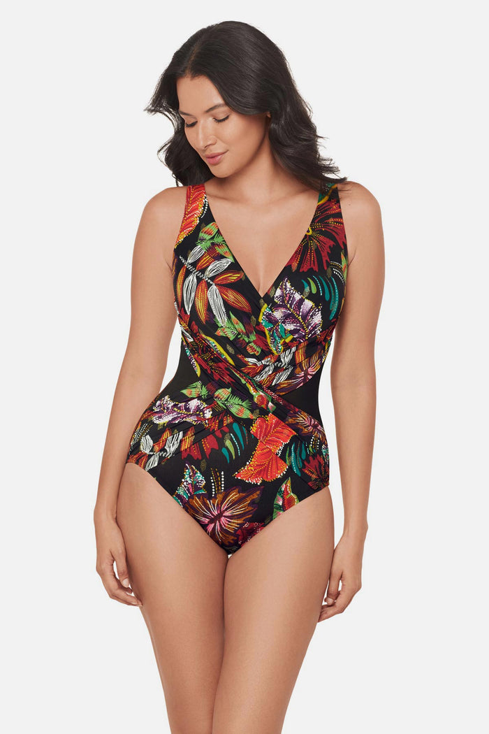 Woman wearing a multicolored floral printed one-piece swimsuit