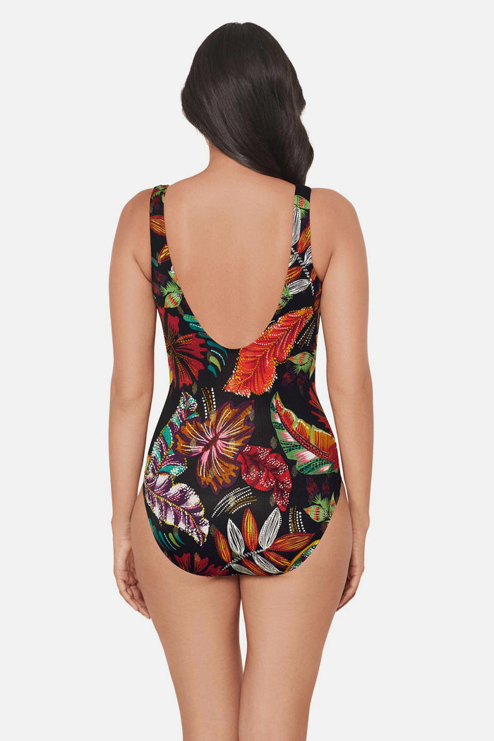 Woman turned away wearing a multicolored floral printed one-piece swimsuit