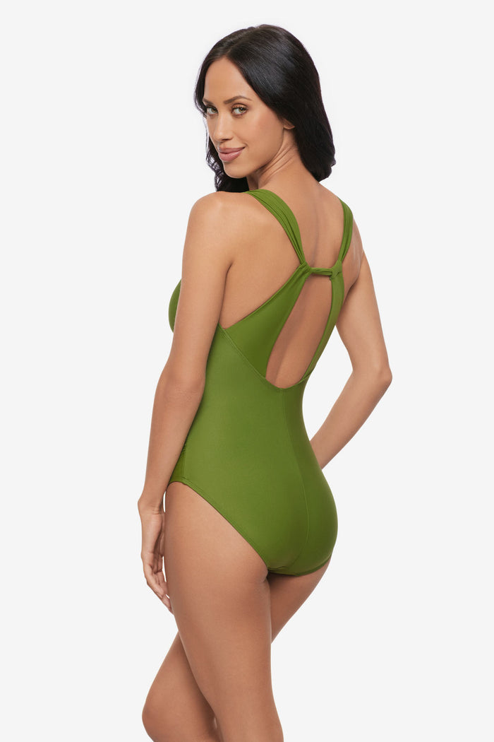 Woman turned left wearing a green one-piece swimsuit