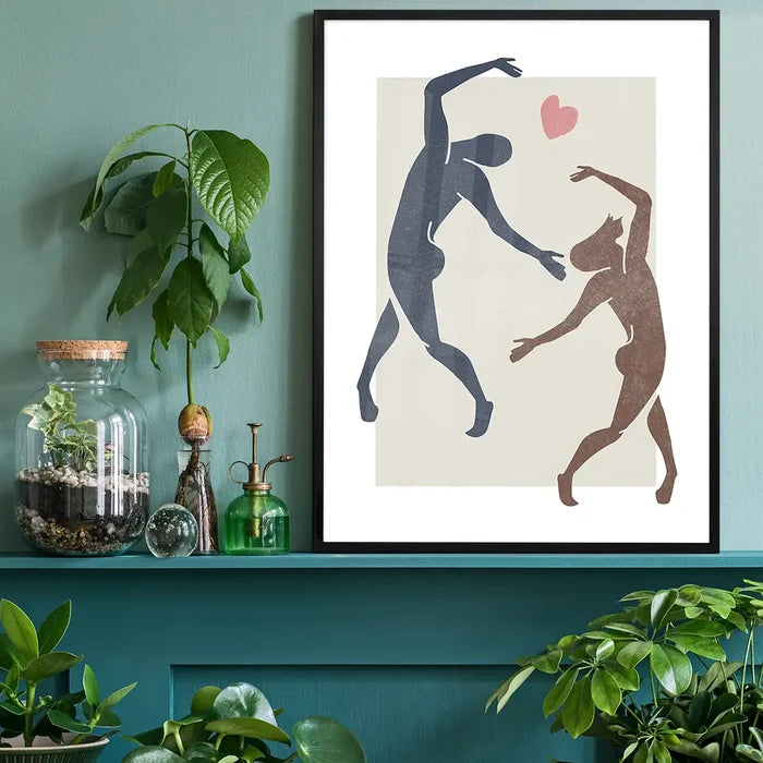 Dancers Watercolour Style Print black framed on a living room shelf