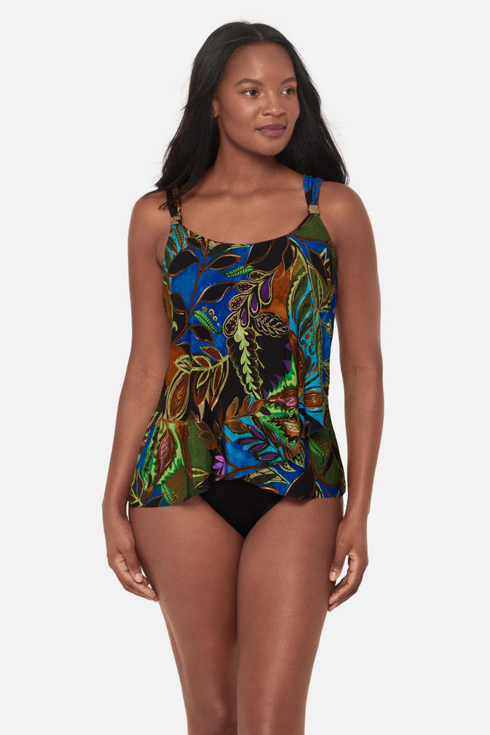 Woman wearing a multicolored tropical print tankini top