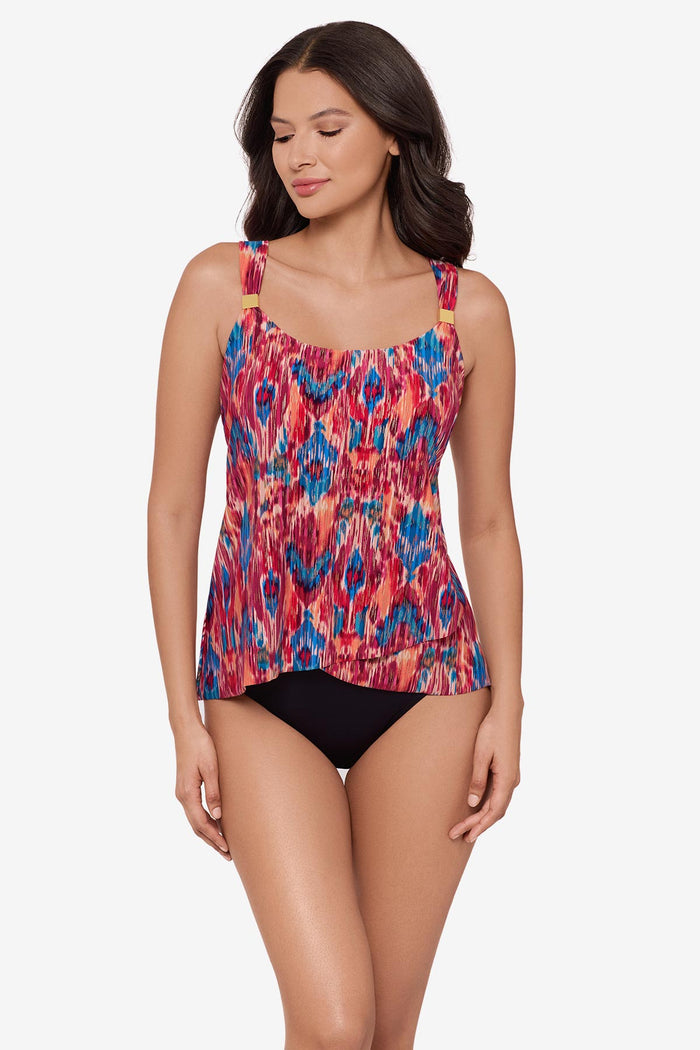 Woman wearing a multicolored tankini top with embellishments on the straps
