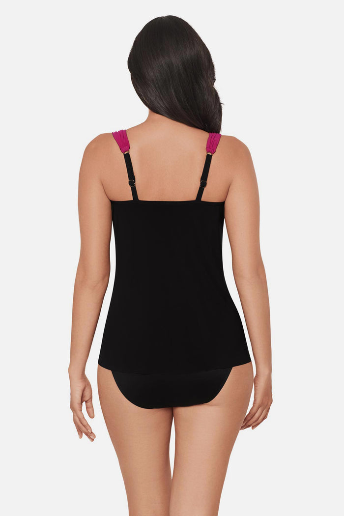 Woman turned away wearing a red, purple and pink floral printed tankini top