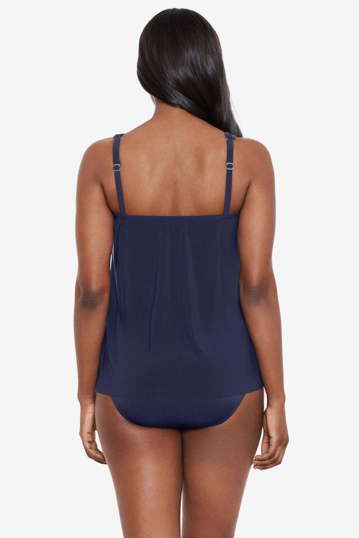 Woman facing away wearing a midnight blue tankini top