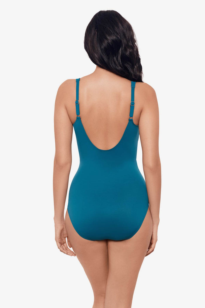 Woman faced away wearing an aegean blue one-piece swimsuit
