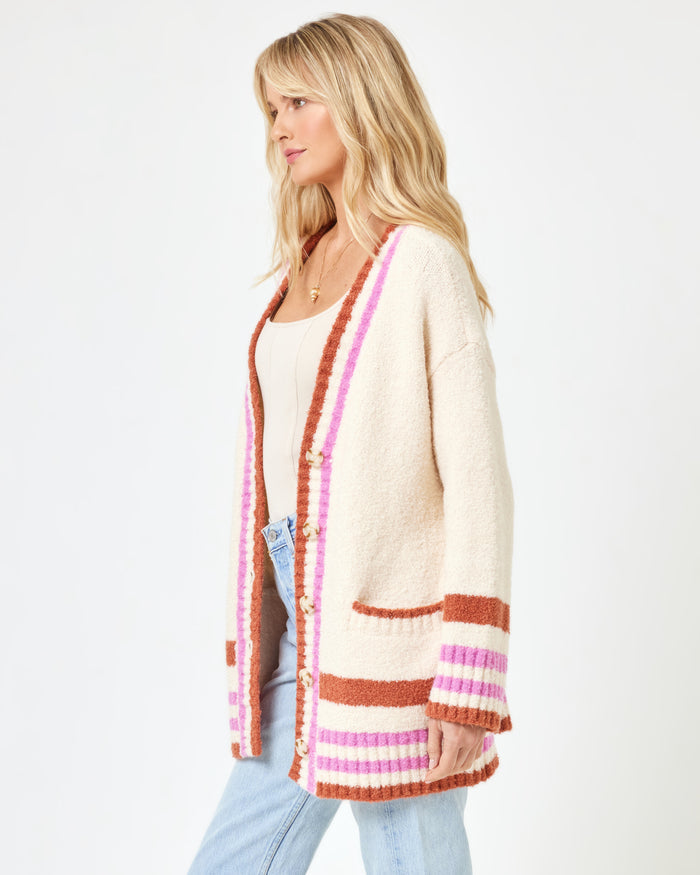 Side view of a model wearing the LSPACE Delta Blooms Sweater in delta blooms jacquard, showing the relaxed silhouette and floral knit pattern of the pullover.