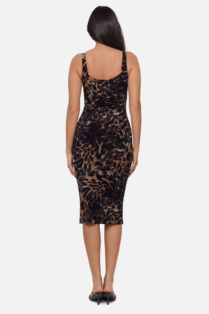 Woman faced away wearing an animal printed sleeveless mid length dress